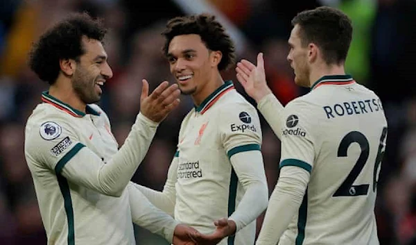 Mo Salah (left) celebrates with Trent Alexander-Arnold and Andy Robertson after putting Liverpool 4-0 up in added time at the end of the first half. Photograph: Tom Jenkins/The Guardian