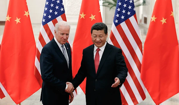 Chinese President Xi Jinping shaking hands with then-Vice President Joe Biden inside the Great Hall of the People in Beijing in 2013 | Reuters