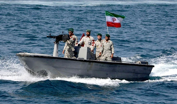 Iranian Revolutionary Guards boats confront an American warship in the Gulf of Oman