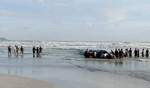 People search Tanjung Balau beach after a boat carrying migrants capsized on Wednesday. (Royal Malaysian Army/Handout via REUTERS)