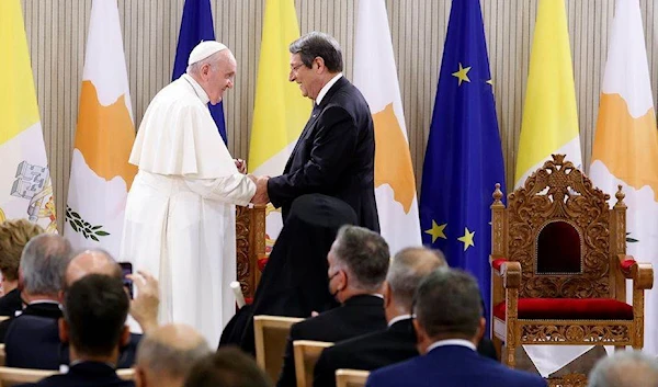 Pope Francis and Cypriot President Nicos Anastasiades greet each other during a meeting with the diplomatic corps and members of civil society in the Ceremonial Hall of the Presidential Palace, in Nicosia, Cyprus, December 2, 2021. (Reuters)