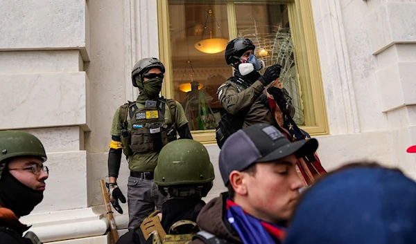 Men wearing tactical gear during the capitol riot on January 6