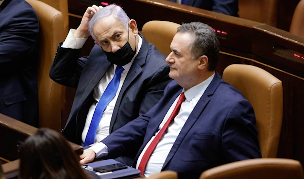 Then-Israeli occupation Prime Minister Benjamin Netanyahu and then-Finance Minister Israel Katz attend the swearing in of the new occupation government at the Knesset in occupied Al-Quds, on June 13, 2021