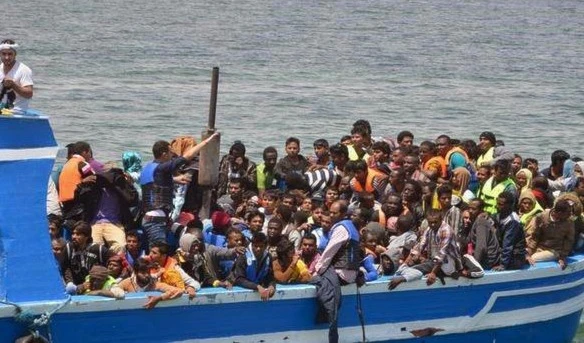 Illegal migrants seen on a boat after being rescued by the Tunisian navy off the coast near Ben Guerdane, Tunisia, June 10, 2015.