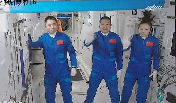 Screen image captured at Beijing Aerospace Control Center in Beijing, capital of China, Oct. 16, 2021 shows three Chinese astronauts, Zhai Zhigang (C), Wang Yaping (R) and Ye Guangfu (L), waving after entering the space station core module Tianhe. /Xinhua