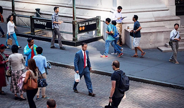 Pedestrians walk along Wall Street, NYC on June 20, 2016. (Getty)