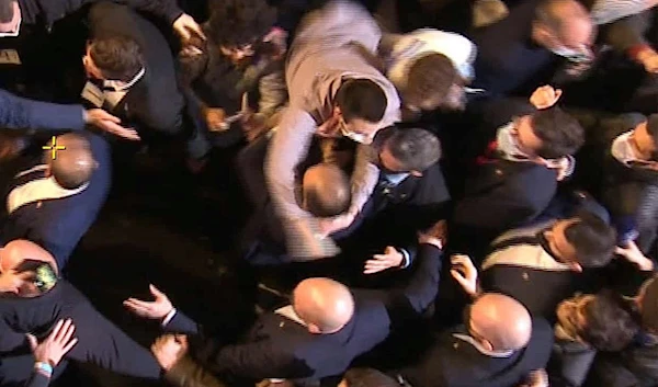 A man grabs French presidential candidate Eric Zemmour during his first campaign (AFP/Getty Images)