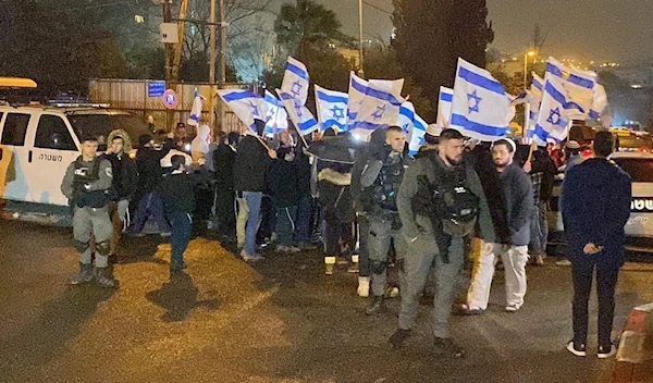 Israeli settlers marching in Sheikh Jarrah under the protection of the Israeli occupation forces