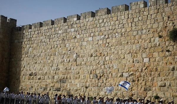 Israeli settlers along the walls surrounding the Old City of Al-Quds, May 10 (Reuters)