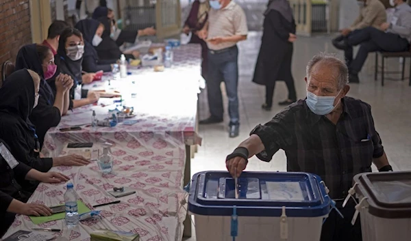 A citizen casts his vote in the Iranian presidential elections (AFP)