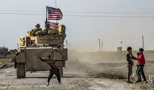 A US tank patrols oil field in Hasaka province (AFP)