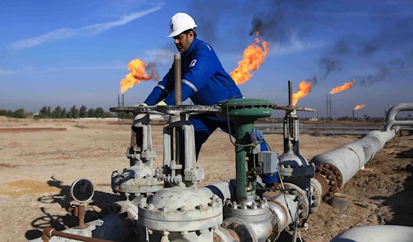 A worker operates valves in Nihran Bin Omar field north of Basra, Iraq, on January 12, 2017 | AP