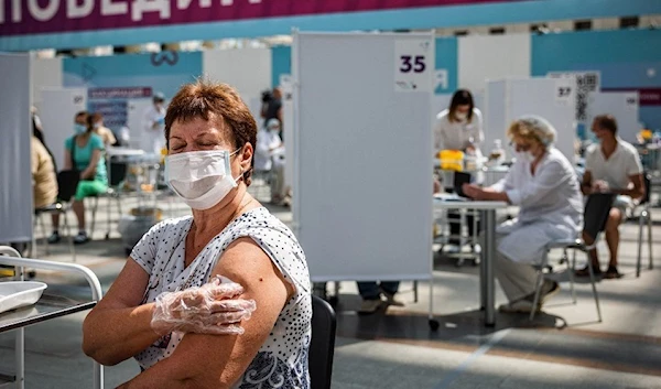 A woman receives a dose of the coronavirus vaccine in Moscow (AFP)