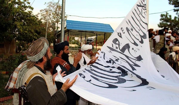 Taliban fighters pray while raising their flag at the Ghazni provincial governor’s house, in Ghazni, southeastern, Afghanistan, August 15, 2021 | AP