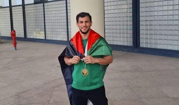 Fethi Nourine, draped in the Palestinian flag