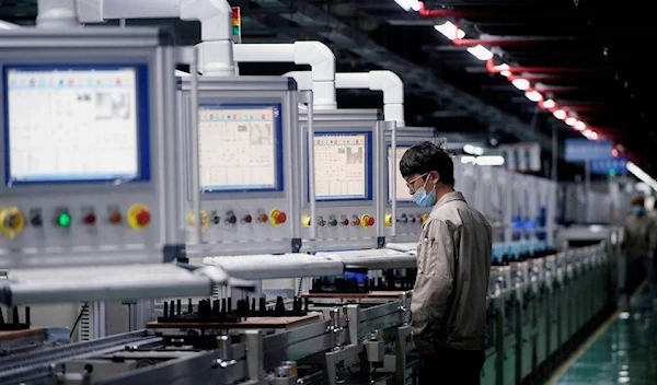 An employee working on an electric vehicle battery production line in Anhui Province, China (Reuters)