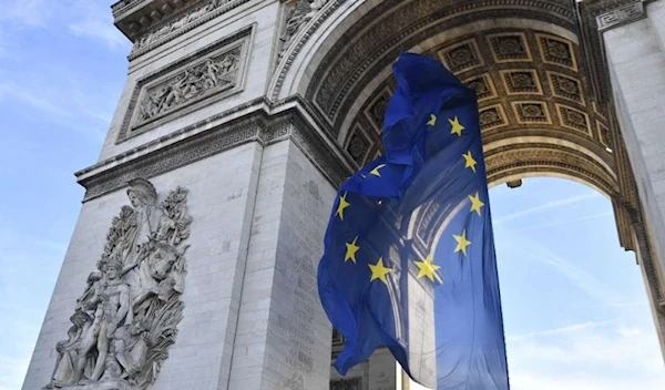 The EU flag waving under the Arc de Triomphe, Paris, France