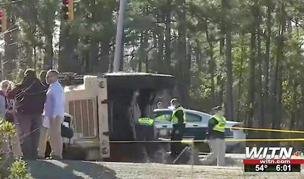 Authorities investigate into the scene where the truck rolled over, in an image taken from a video (AP)