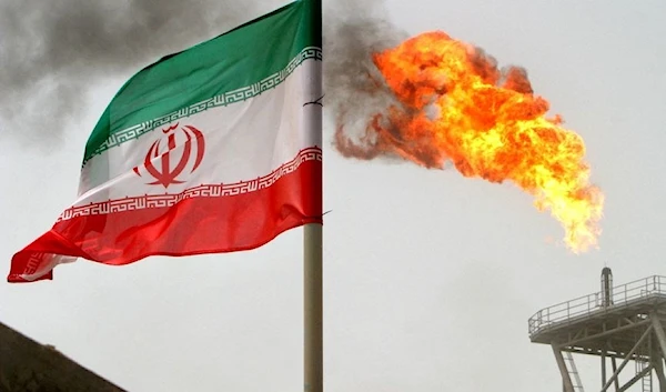 A gas flare on an oil production platform alongside an Iranian flag in the Gulf (Reuters)