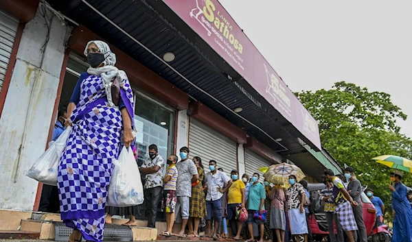 A woman carrying food bags from a state-run supermarket, September 3 2021(AFP/Getty)