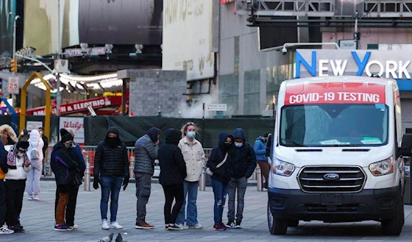 People line up for a COVID-19 test in Times Square as Omicron continues to spread in New York, December 26, 2021 (Reuters)