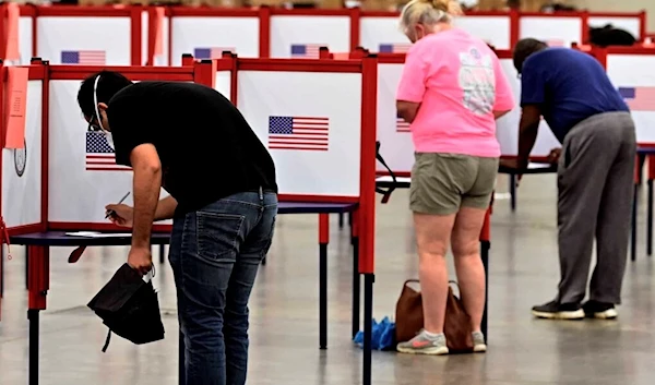 Voters cast out primary ballots at the Kentucky Exposition Center in Louisville, June 23, 2020 (Source: AP Photo)