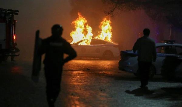 (A police car on fire during a protest in Almaty on Wednesday (Reuters