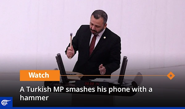 A Turkish MP smashes his phone with a hammer