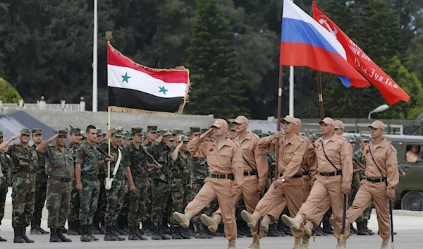 Russian and Syrian soldiers during a rehearsal for a military parade at Hmeimim airbase, Latakia, Syria in May 2016 (EPA)