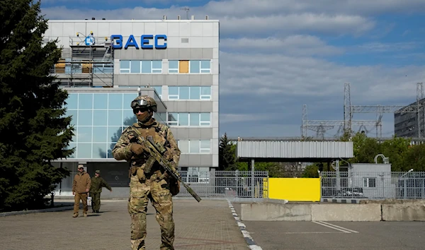 A Russian serviceman stands guard in an area of the Zaporozhye Nuclear Power Station, on May 1, 2022 (AP Photo, File)