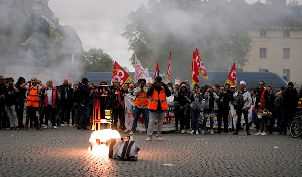 People gather for a protest for salary raise, in Paris, Tuesday, Oct. 18, 2022 (AP Photo/Francois Mori)