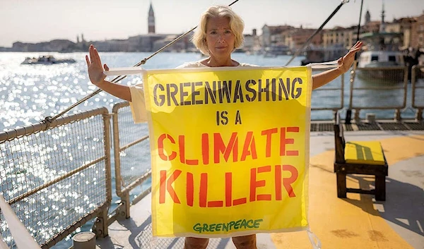 Emma Thompson holding a banner against greenwashing (Greenpeace)