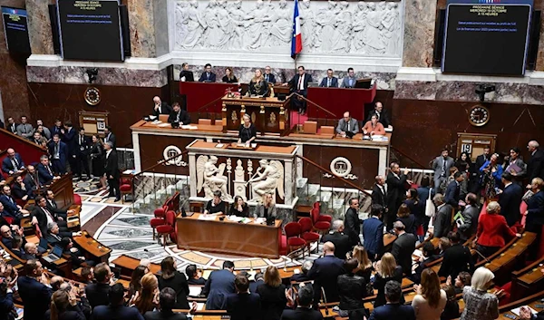 Left-wing NUPES coalition MPs leave the main chamber of the Assemblée Nationale during the announcement of the recourse to Article 49.3 by Prime Minister Elisabeth Borne, in Paris, on October 19, 2022. EMMANUEL DUNAND / AFP