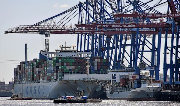 Port cranes load container ships at the import and export harbor in Hamburg, Germany, Tuesday, March 19, 2022 (AP Photo/Martin Meissner,file)