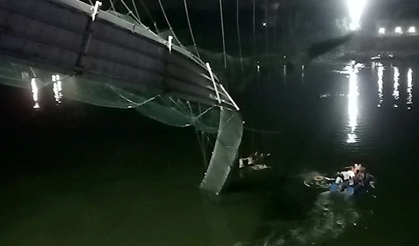 A view shows a damaged part of a suspension bridge after it collapsed in Morbi town in the western state of Gujarat, India, October 30, 2022 (Reuters)