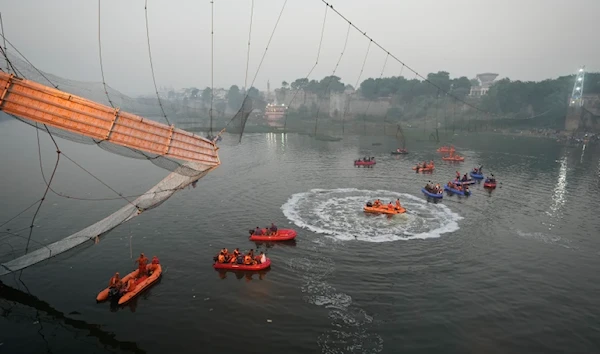 Rescue efforts at the Gujarat Bridge (AFP)