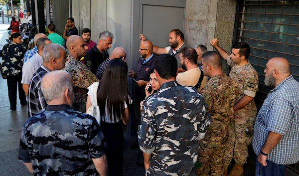 People waiting outside a Fransabank branch to withdraw money, in Beirut, Lebanon, Monday, Sept. 26, 2022 (AP Photo/Bilal Hussein)