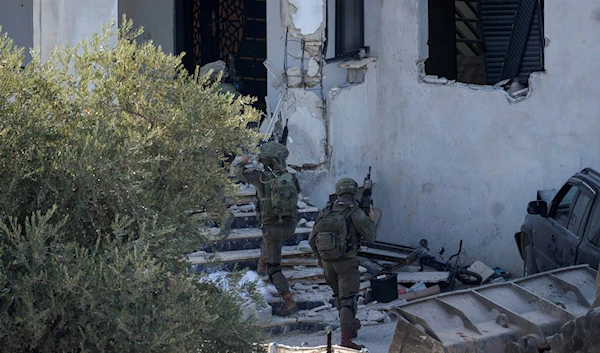 Israeli soldiers surround a Palestinian house during a raid in the village of Deir al-Hatab near the West Bank city of Nablus, Wednesday, Oct. 5, 2022 (AP Photo/Majdi Mohammed)