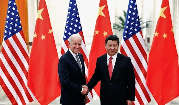 Chinese President Xi Jinping shakes hands with U.S. Vice President Joe Biden (L) inside the Great Hall of the People in Beijing December 4, 2013. REUTERS/Lintao Zhang/Pool//File Photo