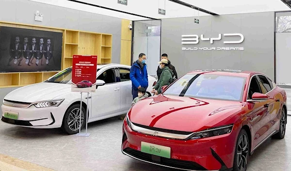 Customers inspect new BYD models in Beijing earlier this year. [Photo provided to China Daily]