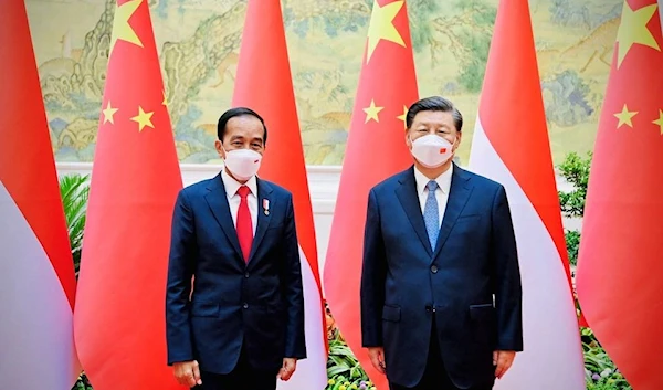 Indonesia's President Joko Widodo and Chinese President Xi Jinping stands pose for pictures during their meeting in Beijing, China, July 26, 2022. (Reuters)