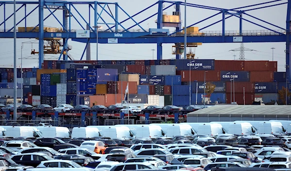 Cars and containers are pictured at the 'duisport logport' logistics center at the river Rhine in Duisburg, Germany, Friday, Oct. 28, 2022 (AP Photo/Michael Sohn, file)