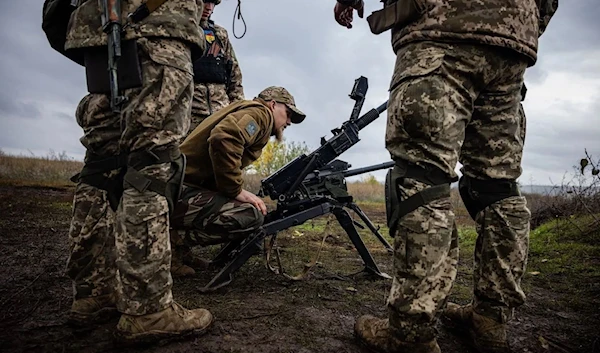 Ukrainian soldiers check their weapons at a position on the front line in Donetsk, Russia, October 24, 2022 (AFP)