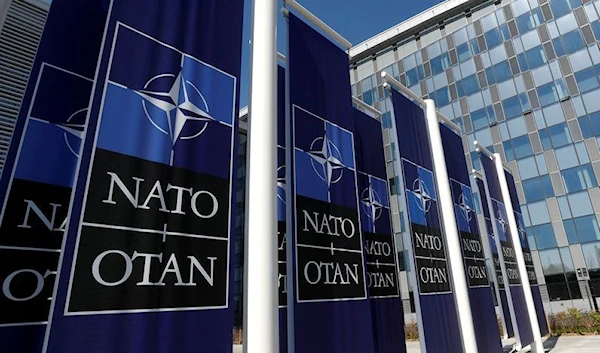 Reuters. FILE PHOTO: Banners displaying the NATO logo are placed at the entrance of new NATO headquarters during the move to the new building, in Brussels, Belgium April 19, 2018. REUTERS/Yves Herman