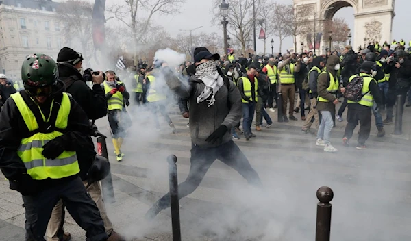 Police use tear gas during yellow vests protest in Paris.