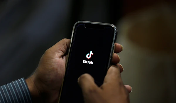 A man opens social media app 'Tik Tok' on his cell phone, in Islamabad, Pakistan, Tuesday, July 21, 2020 (AP Photo/Anjum Naveed)