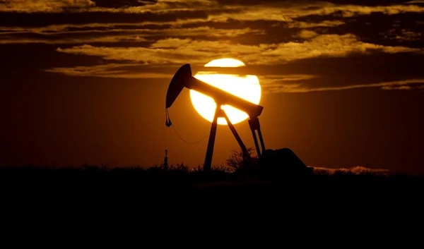 The sun sets behind an idle pump jack near Karnes City, USA. (AP)