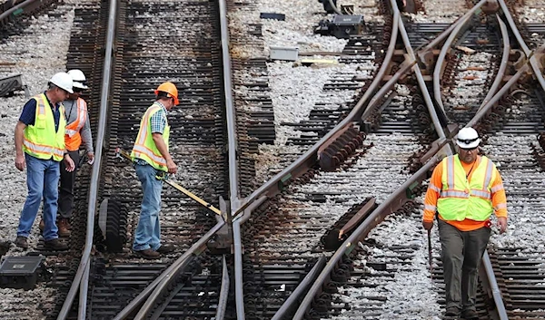 Workers service the tracks at the Metra/BNSF railroad yard in Chicago (Getty Images)