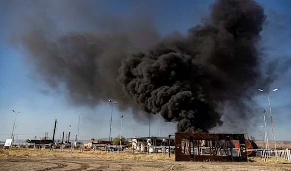 A smoke rises from an oil depot struck by Turkish air force near the town of Qamishli, Syria, Wednesday, Nov. 23, 2022 (AP Photo/Baderkhan Ahmad)