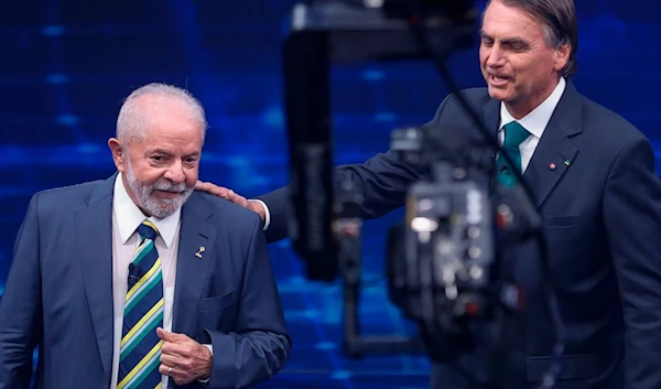 Brazil's former President Luiz Inacio Lula da Silva, who is running for office again, left, faces Jair Bolsonaro in a presidential debate at Bandeirantes Television in Sao Paulo, Brazil, Sunday, Oct. 16, 2022 (AP)